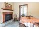Cozy dining room with a fireplace, mantle and hardwood floors, perfect for Gathering meals and gatherings at 7258 N Richardson Dr, Morgantown, IN 46160