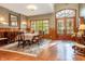 Formal dining room featuring wood floors, decorative wall paper, wainscotting and a large arched window and door at 7258 N Richardson Dr, Morgantown, IN 46160