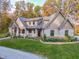 Stunning stone-clad home boasts professional landscaping, elegant roofline, and a welcoming front porch at 7258 N Richardson Dr, Morgantown, IN 46160