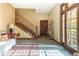 Welcoming foyer features a wooden staircase, large windows and doorway to the exterior, and elegant decor at 7258 N Richardson Dr, Morgantown, IN 46160