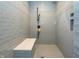 Modern walk-in shower features light blue tiling, shower head and seat in updated bathroom at 7258 N Richardson Dr, Morgantown, IN 46160