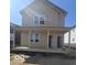 Charming two-story home with covered porch and neutral siding, bathed in sunlight at 2018 Rembrandt St, Indianapolis, IN 46202