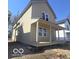 Exterior view of a charming two-story home with a covered porch and neutral siding at 2018 Rembrandt St, Indianapolis, IN 46202