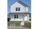 Two story new construction home with white siding, black metal roof, and front porch at 2018 Rembrandt St, Indianapolis, IN 46202