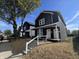 Two story new construction home with black siding and front porch at 2018 Rembrandt St, Indianapolis, IN 46202