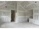 A large empty room in progress with high ceilings, a doorway, and white walls at 2018 Rembrandt St, Indianapolis, IN 46202