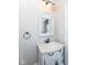 Small bathroom with white vanity and a decorative mirror at 4902 N Park Ave, Indianapolis, IN 46205