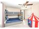 Bedroom with blue bunk beds, a ceiling fan, and a colorful play tent for a playful space at 4902 N Park Ave, Indianapolis, IN 46205