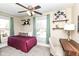 Comfortable bedroom with a desk, daybed, shelves with decorations, ceiling fan, and a large window at 4902 N Park Ave, Indianapolis, IN 46205
