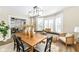 Dining room with wooden table, large windows, bench seating, and modern chandelier at 4902 N Park Ave, Indianapolis, IN 46205