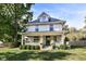 Two-story house with gray brick and white siding, metal roof, and porch at 4902 N Park Ave, Indianapolis, IN 46205