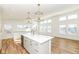 Bright kitchen features white cabinets, quartz countertops, and an island at 4902 N Park Ave, Indianapolis, IN 46205