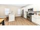Bright kitchen with white cabinets, stainless steel appliances, and hardwood floors at 4902 N Park Ave, Indianapolis, IN 46205