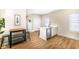 Quaint kitchenette featuring white cabinets, stainless steel appliances, and durable wood floors at 4902 N Park Ave, Indianapolis, IN 46205