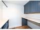 Laundry room with dark blue cabinets and quartz countertops at 4902 N Park Ave, Indianapolis, IN 46205