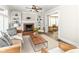 Bright living room with fireplace, built-in bookshelves, and a view into the sunroom at 4902 N Park Ave, Indianapolis, IN 46205