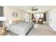 Spacious main bedroom with a ceiling fan, seating area, french doors, and neutral decor at 4902 N Park Ave, Indianapolis, IN 46205