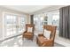 Cozy seating area with two chairs, a window with blinds, and access to a balcony at 4902 N Park Ave, Indianapolis, IN 46205