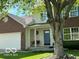 Inviting home facade with a porch swing and a brick front, enhanced by a lush lawn at 534 Austrian Way, Avon, IN 46123