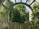 Whimsical garden arch leading to a secluded outdoor space, framed by abundant greenery at 534 Austrian Way, Avon, IN 46123