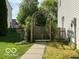 Enchanting side yard with a decorative archway that leads to a garden area and walkway at 534 Austrian Way, Avon, IN 46123