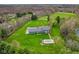 Aerial shot of a sprawling estate with a pool, lush lawns, and surrounded by mature trees and serene landscapes at 5911 N 400 W, Bargersville, IN 46106