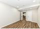 Empty basement room with wood flooring and access to other rooms at 6252 Sugar Maple Dr, Zionsville, IN 46077