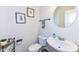 Charming powder room with pedestal sink and round mirror at 6252 Sugar Maple Dr, Zionsville, IN 46077