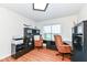 Bright home office with hardwood floors, L-shaped desk, and built-in shelving at 6252 Sugar Maple Dr, Zionsville, IN 46077