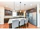 Modern kitchen with dark cabinetry, granite counters, and island at 6252 Sugar Maple Dr, Zionsville, IN 46077