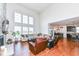 Large living area with hardwood floors, open floor plan, and kitchen access at 6252 Sugar Maple Dr, Zionsville, IN 46077