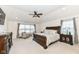 Main bedroom with carpeted floors, large windows and ceiling fan at 6252 Sugar Maple Dr, Zionsville, IN 46077