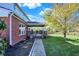 A brick walkway leading to the covered deck and backyard, with a well-manicured lawn and mature trees at 794 Princeton Ln, Westfield, IN 46074