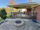 Covered patio with brick base and wooden deck with a built-in fire pit in a spacious backyard at 794 Princeton Ln, Westfield, IN 46074