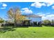 Large grassy backyard with a mature tree and a view of the home's back exterior on a sunny day at 794 Princeton Ln, Westfield, IN 46074