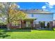 Spacious backyard with a well-maintained lawn, brick patio, covered deck, and mature trees providing shade at 794 Princeton Ln, Westfield, IN 46074