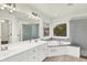 Elegant bathroom featuring dual sinks, modern lighting, a soaking tub, and a glass shower at 794 Princeton Ln, Westfield, IN 46074