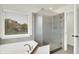 Modern bathroom showcasing a glass enclosed shower and a soaking tub by the window at 794 Princeton Ln, Westfield, IN 46074