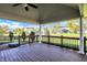 Wide angle of a covered deck space with wood floors and backyard views at 794 Princeton Ln, Westfield, IN 46074