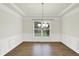 Open dining room features hardwood flooring and a modern hanging chandelier at 794 Princeton Ln, Westfield, IN 46074