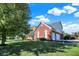 Two story red brick and vinyl home with a manicured front lawn and three-car garage at 794 Princeton Ln, Westfield, IN 46074