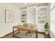 Bright home office featuring custom built-in shelving, modern desk, neutral decor, and plenty of natural light at 794 Princeton Ln, Westfield, IN 46074
