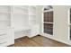 Home office featuring custom built-in shelving, laminate wood floors, modern desk, and lots of natural light at 794 Princeton Ln, Westfield, IN 46074