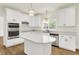 Bright kitchen with white cabinets, quartz countertops, a kitchen island, and stainless steel appliances at 794 Princeton Ln, Westfield, IN 46074