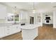Open concept kitchen featuring a kitchen island with white cabinets, stainless steel appliances, and hardwood floors at 794 Princeton Ln, Westfield, IN 46074