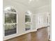 Sun-filled living room with wood floors, large windows, French doors, and white trim at 794 Princeton Ln, Westfield, IN 46074