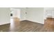 Open-concept living room featuring hardwood floors and access to a study with built-ins at 794 Princeton Ln, Westfield, IN 46074