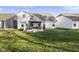 Exterior back of home with a covered patio, hot tub, and lush green grass at 17871 Paula, Westfield, IN 46074