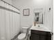 Bathroom featuring tiled floor, white shower curtain, toilet, vanity, mirror and artwork at 17871 Paula, Westfield, IN 46074