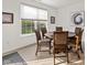 Bright dining area features a round table, six chairs, and a large window overlooking the green yard at 17871 Paula, Westfield, IN 46074
